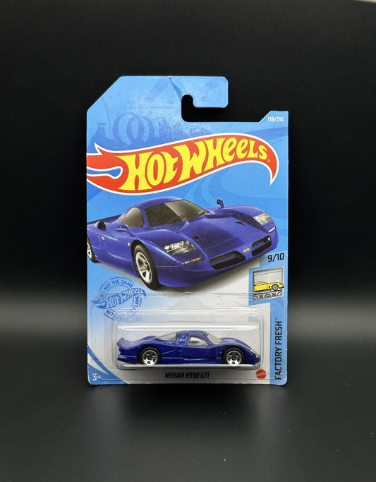 Hot Wheels toy car packaging with a blue Nissan r390 gti car on a black background
