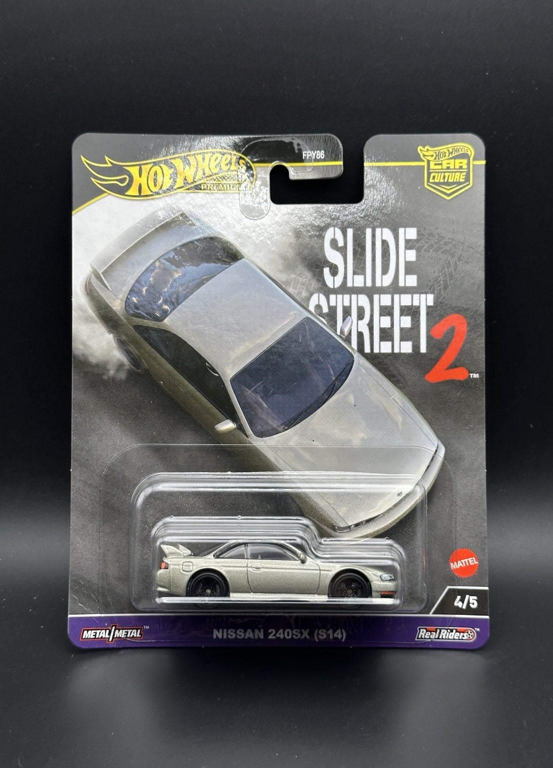 Hot Wheels Slide Street 2 toy car packaging on a dark background
