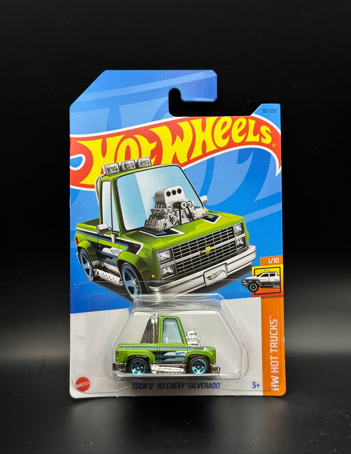 Hot Wheels toy truck in packaging on a black background