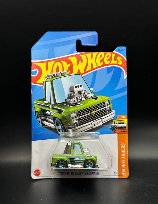 Hot Wheels toy truck in packaging on a black background
